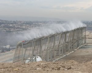 A spray-type mist odor/vapor control system actively treating a landfill's working face.
